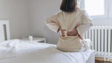 A woman massages her sore back