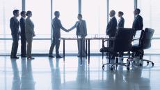 Business people shaking hands in a conference room