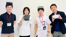 Representatives from Jolly Good and Aichi Medical University Hospital's Pain Center wear the Jolly Good VR headset