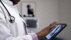 Healthcare provider looking at x-ray images on a tablet
