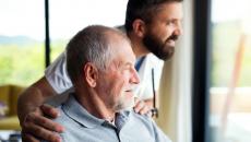 An older man with a caregiver