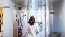 Healthcare worker walking down the hallway in a hospital